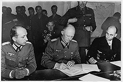 Colonel General Alfred Jodl signs the Instrument of Surrender